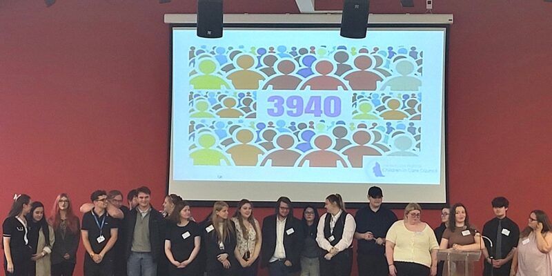 A photo of young people in front of an image featuring the number 3940