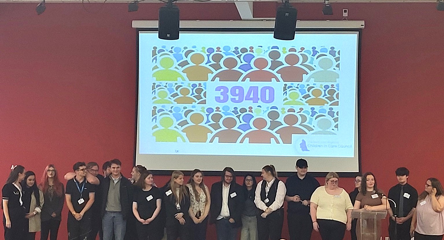 A photo of young people in front of an image featuring the number 3940