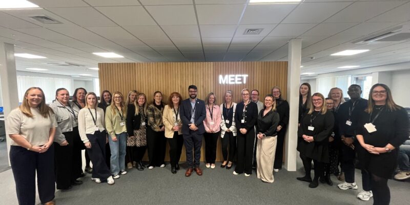 Image of a large group of people smiling for the camera, at the launch of the Family Help Point.