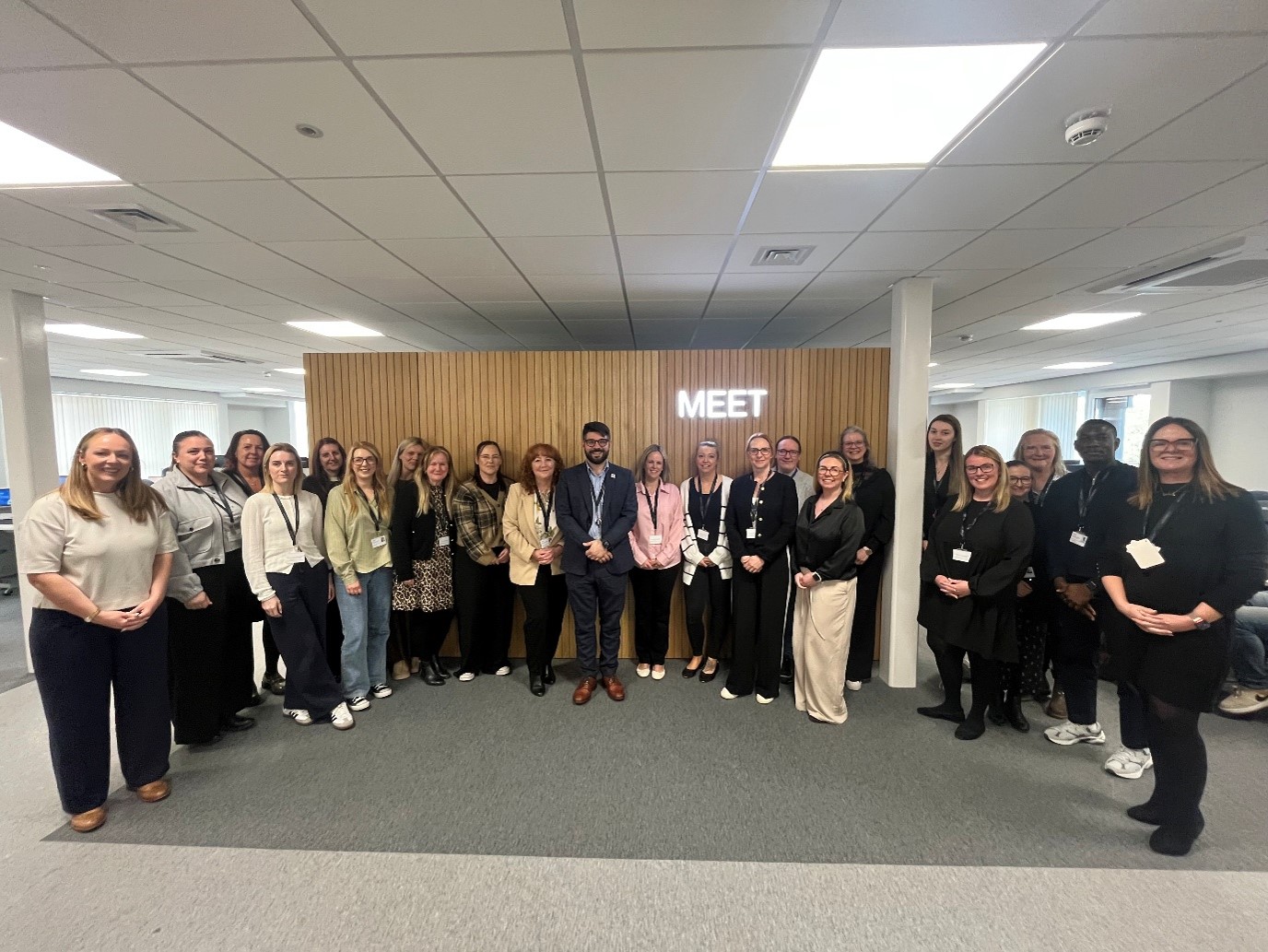 Image of a large group of people smiling for the camera, at the launch of the Family Help Point.
